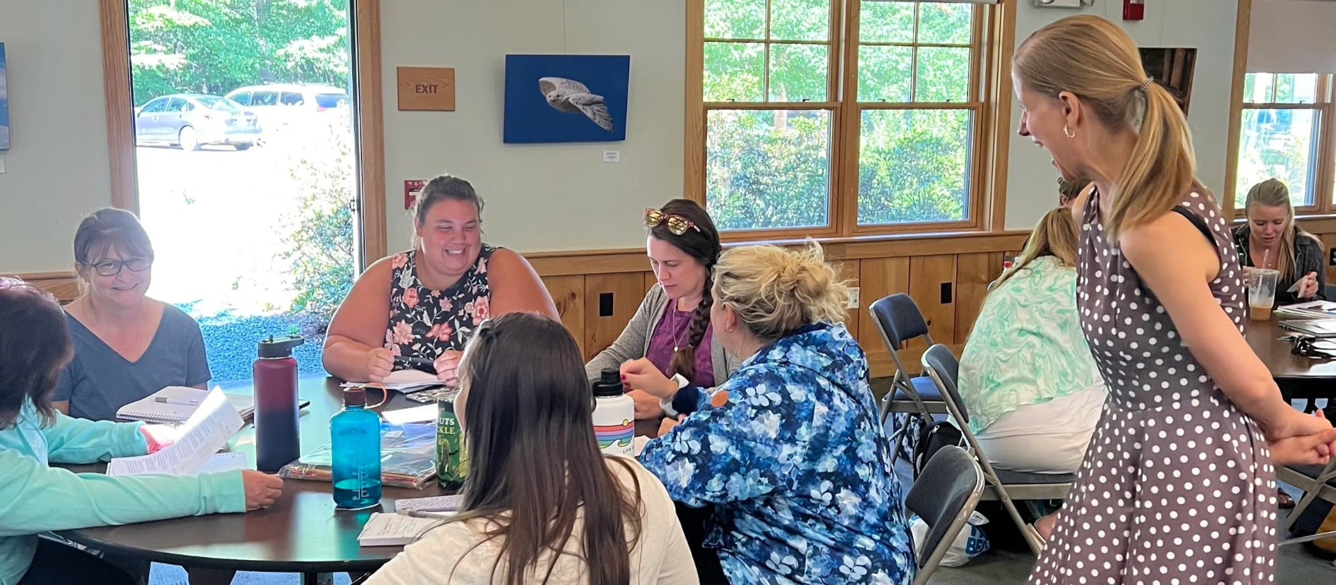 Math Empowered facilitators working with a group of teachers around a table